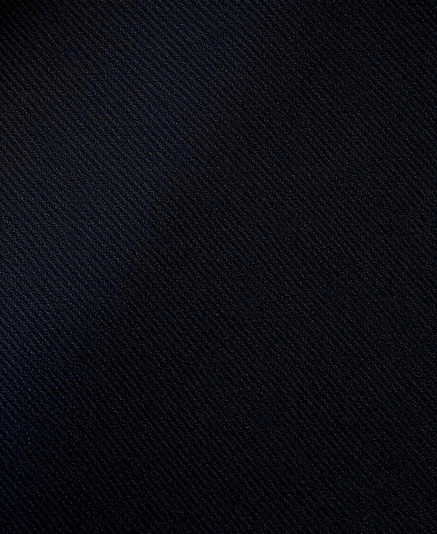 Close-up of charcoal wool suiting fabric with herringbone weave at Auriva, Dubai